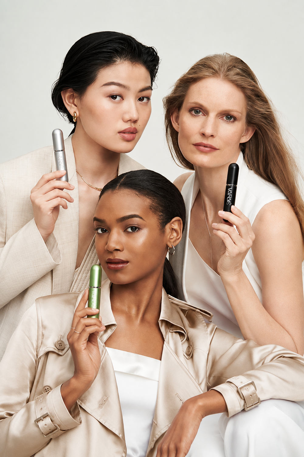 Three women holding VARAÉ ANCHOR in Silver Haze, Noir Black and Lush Green
